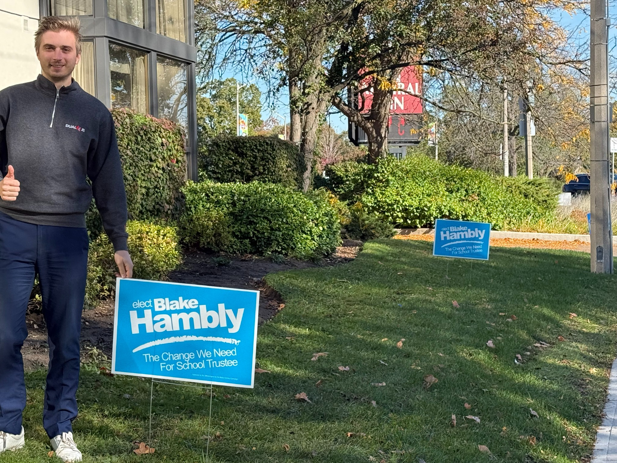 Blake with a campaign lawn sign